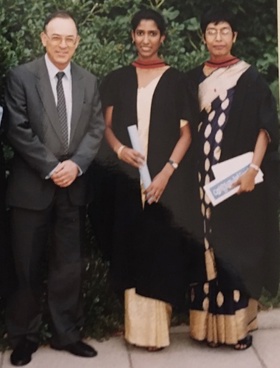 Ruanne stood in the middle of both her parents wearing a sari with her graduation certificate in hand.