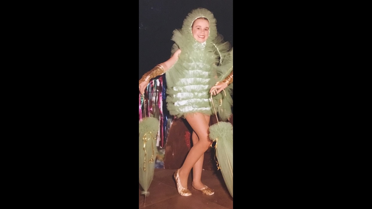 A picture showing a young Elle dressed as a cucumber