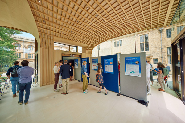 Inside view of the Glass Pavilion with delegates and exhibition boards.