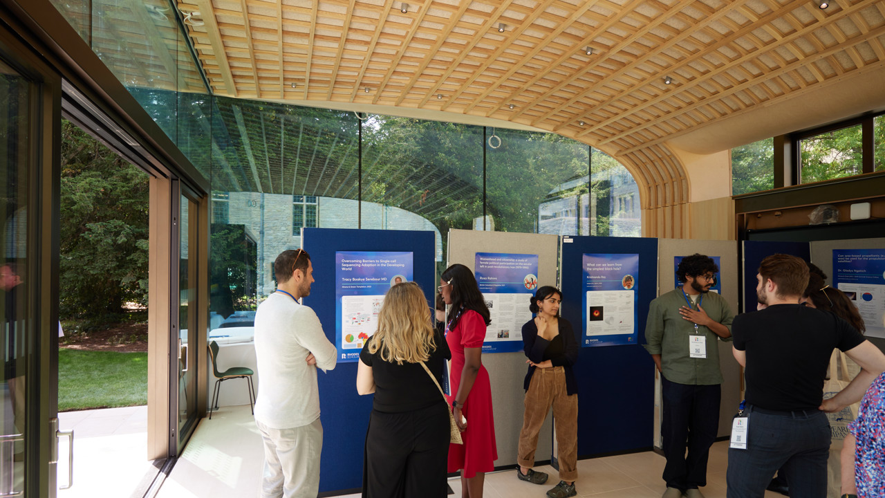 Inside view of the Glass Pavilion with delegates and exhibition boards.