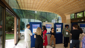 Inside view of the Glass Pavilion with delegates and exhibition boards.