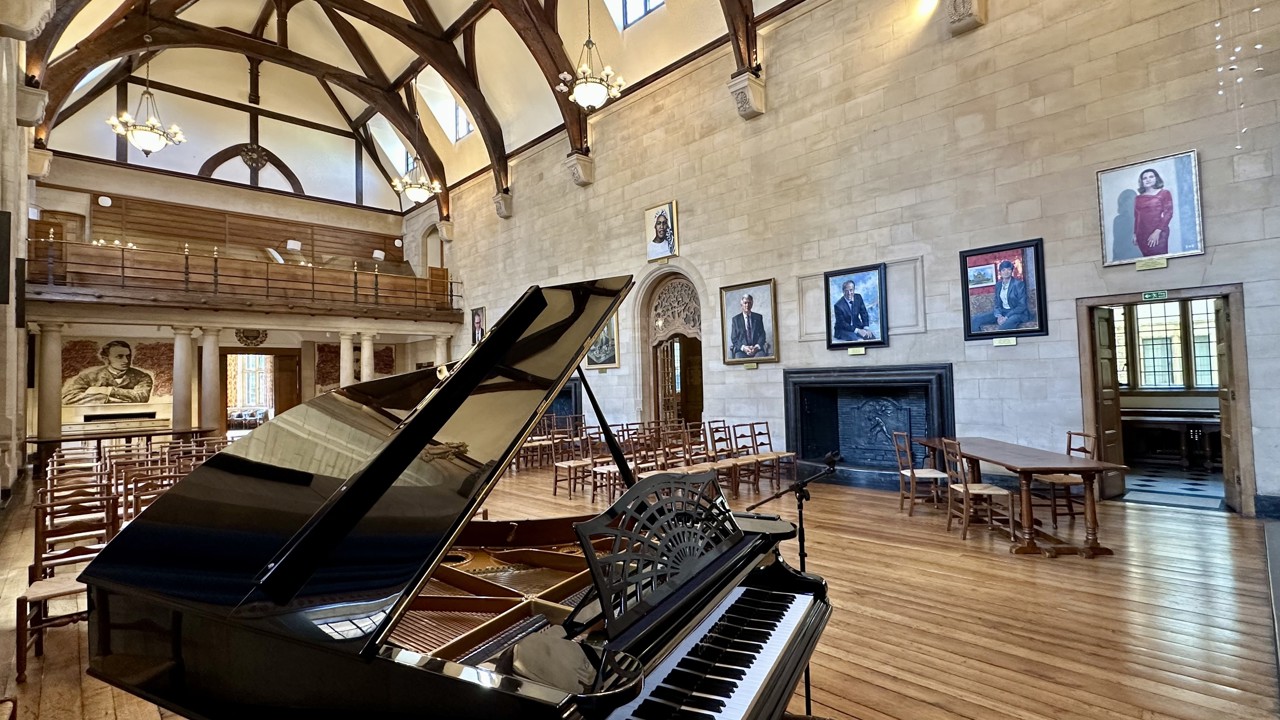 McCall MacBain Hall set up with chairs, with grand piano in the foreground.
