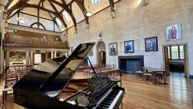 McCall MacBain Hall set up with chairs, with grand piano in the foreground.