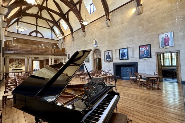 McCall MacBain Hall set up with chairs, with grand piano in the foreground.