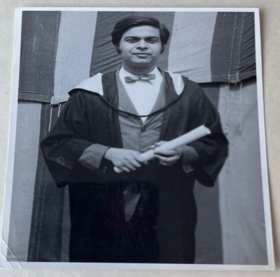 A black-and-white photo showing Jahar in a graduation gown