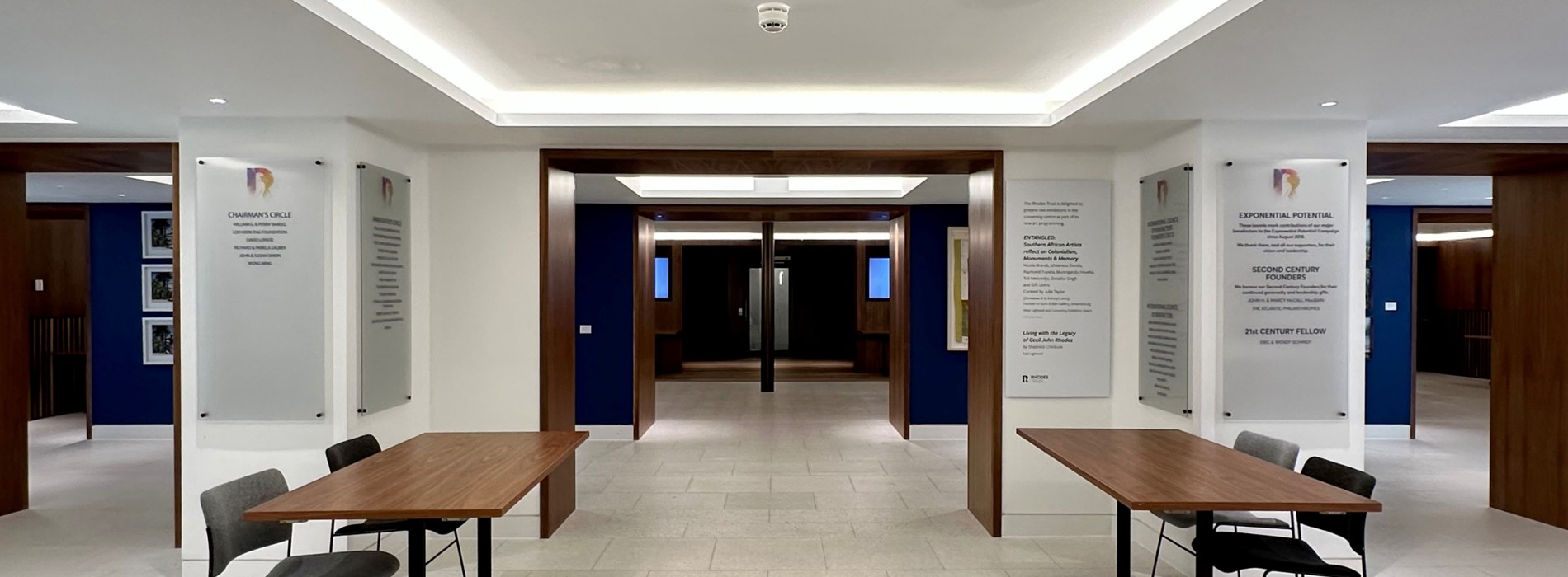 Conference Foyer entrance area with two registration tables and two chairs behind each table.