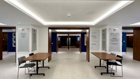 Conference Foyer entrance area with two registration tables and two chairs behind each table.