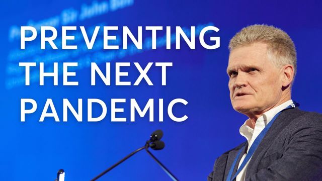 Panellsists speaking below a display screen at the Rhodes policy summit