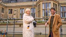 Professor Elleke Boehmer and Luan Staphorst at the parapet during carving work in Jan 2025