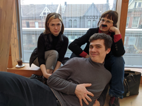 Banuta and her kids: soon laying at the front, daughter to the left, and Banuta frowning wearing a moustache.