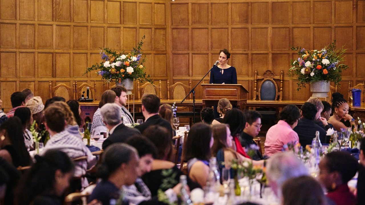 Keynote speaker giving a speech before dinner in McCall MacBain Hall