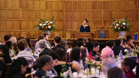 Keynote speaker giving a speech before dinner in McCall MacBain Hall
