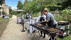 Chefs grilling veggie burgers for a BBQ in the Rhodes House garden.