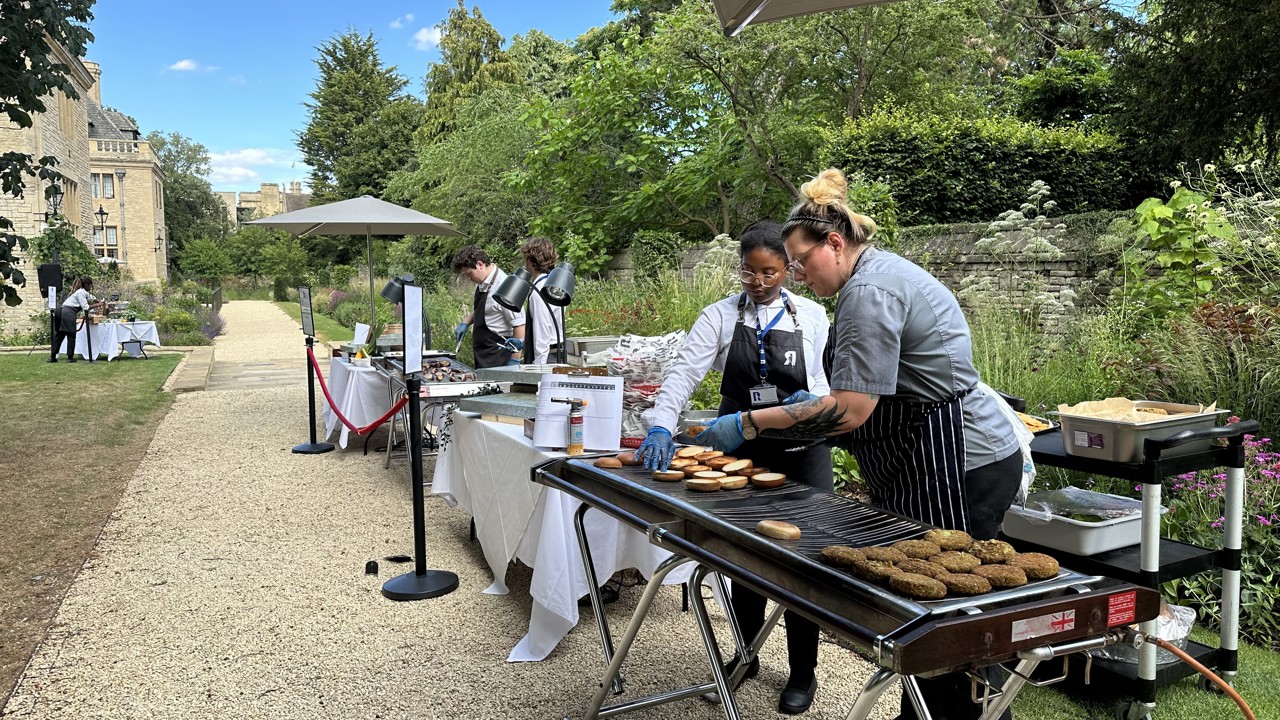 Chefs grilling veggie burgers for a BBQ in the Rhodes House garden.