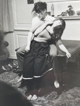 Black and white performance art photo of Banuta falling into the arms of Neil.