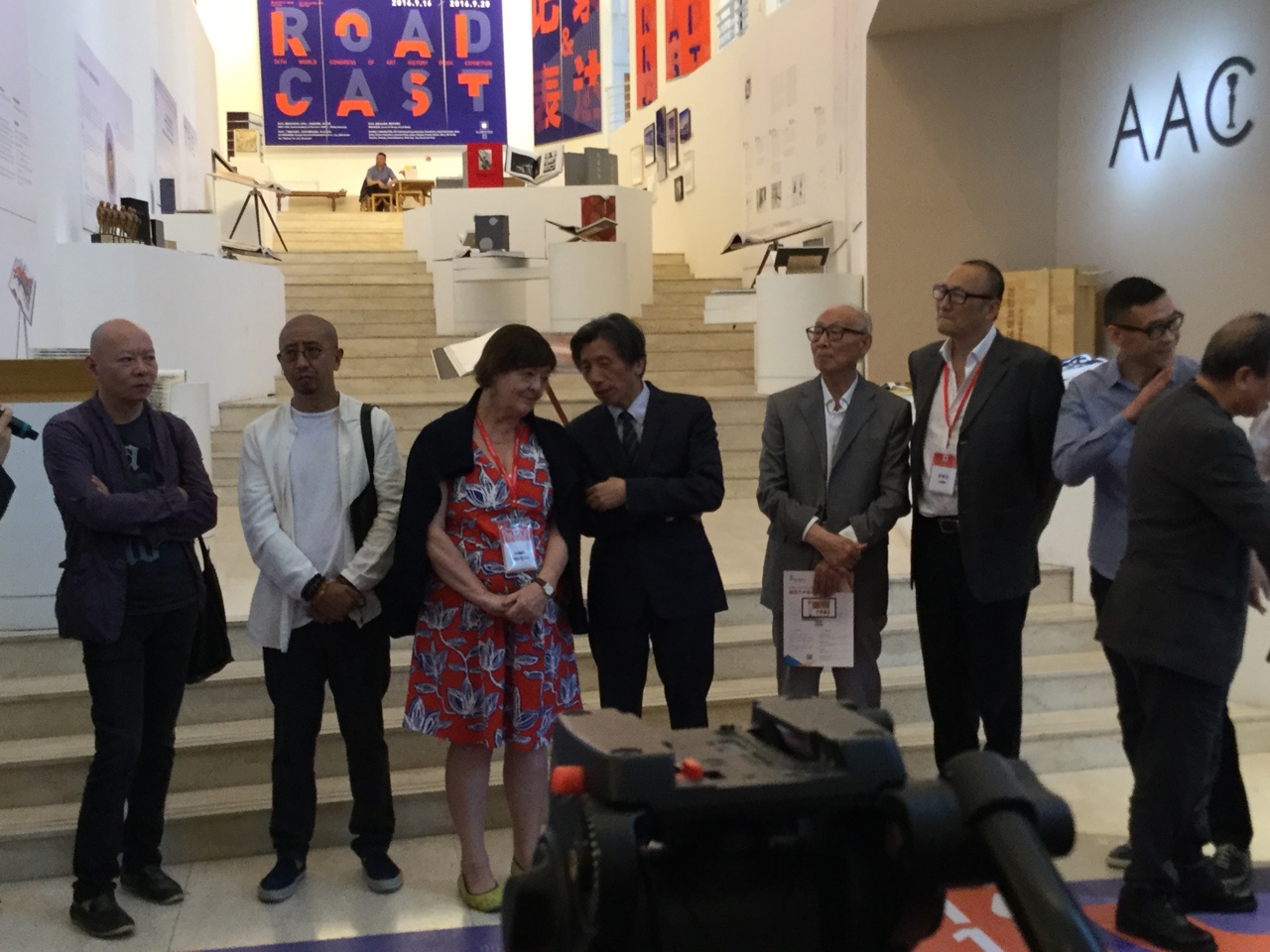Jaynie standing with a group of people who are wearing suits