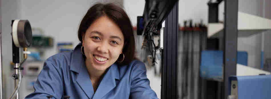 A woman in a lab coat in a laboratory at Oxford