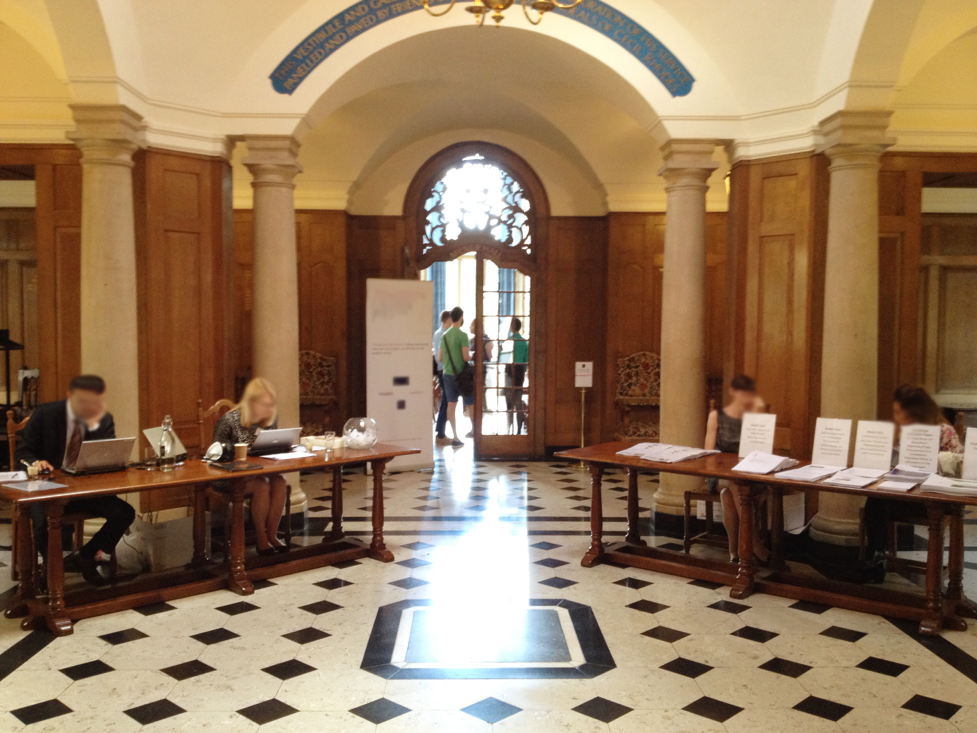 Registration tables set up for a conference at Rhodes House