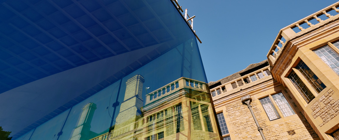 Rhodes House reflected in the glass wall of the new garden pavillion