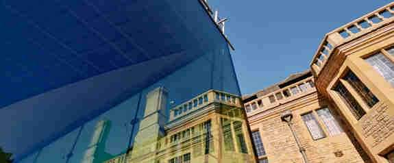 Rhodes House reflected in the glass wall of the new garden pavillion