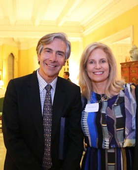 Elliot and Jessica in formal attire stood smiling.