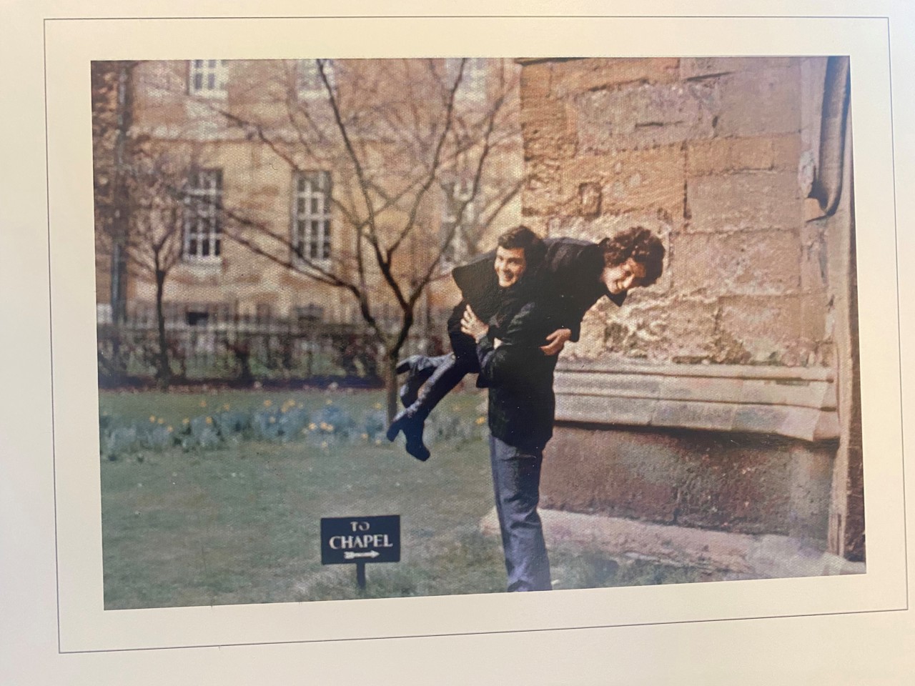 Photo of Nick and Marla smiling, with Nick holding Marla up over his shoulder.