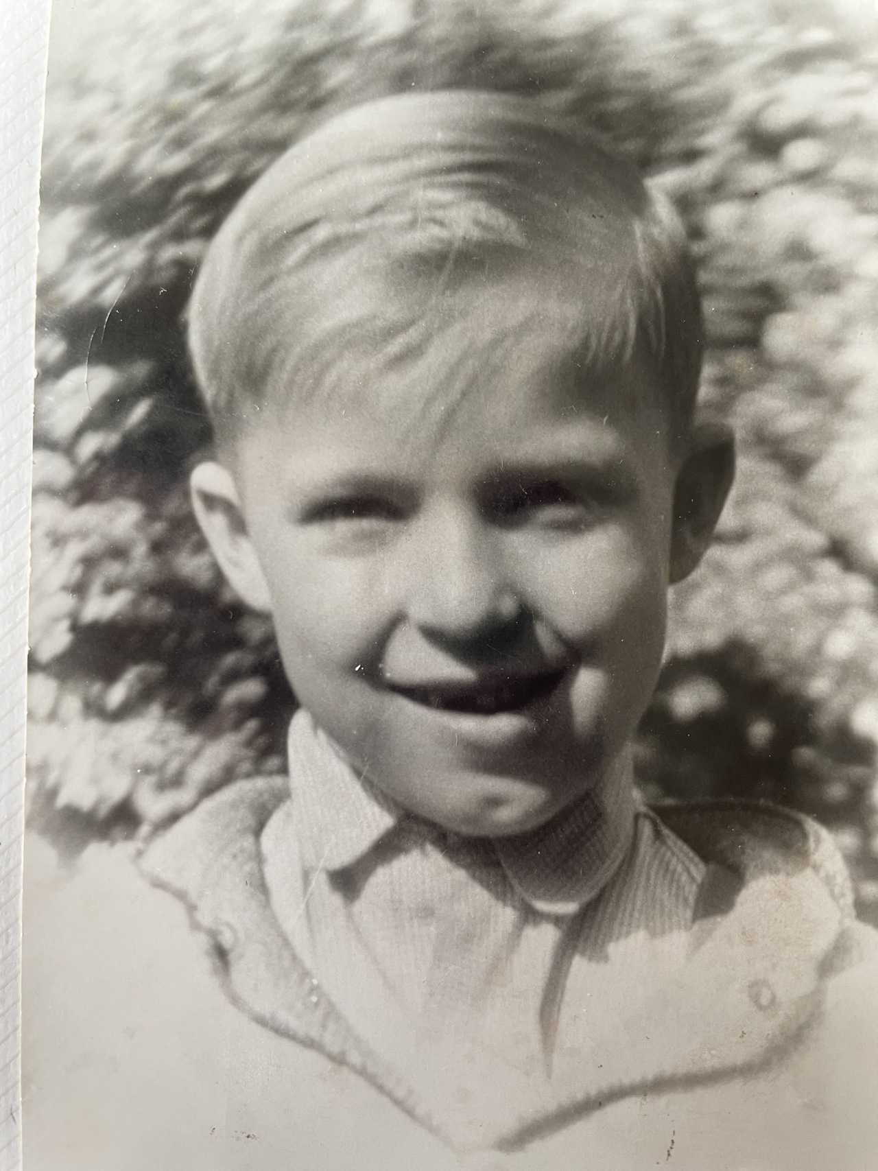 Black and white photo of Geza smiling as a young boy.