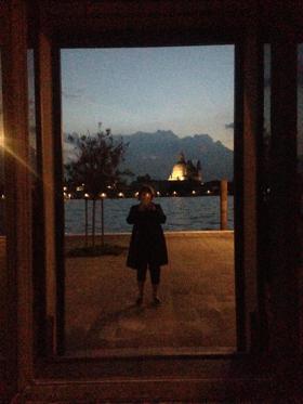 The picture shows Jaynie taking a selfie in a mirror at dusk.