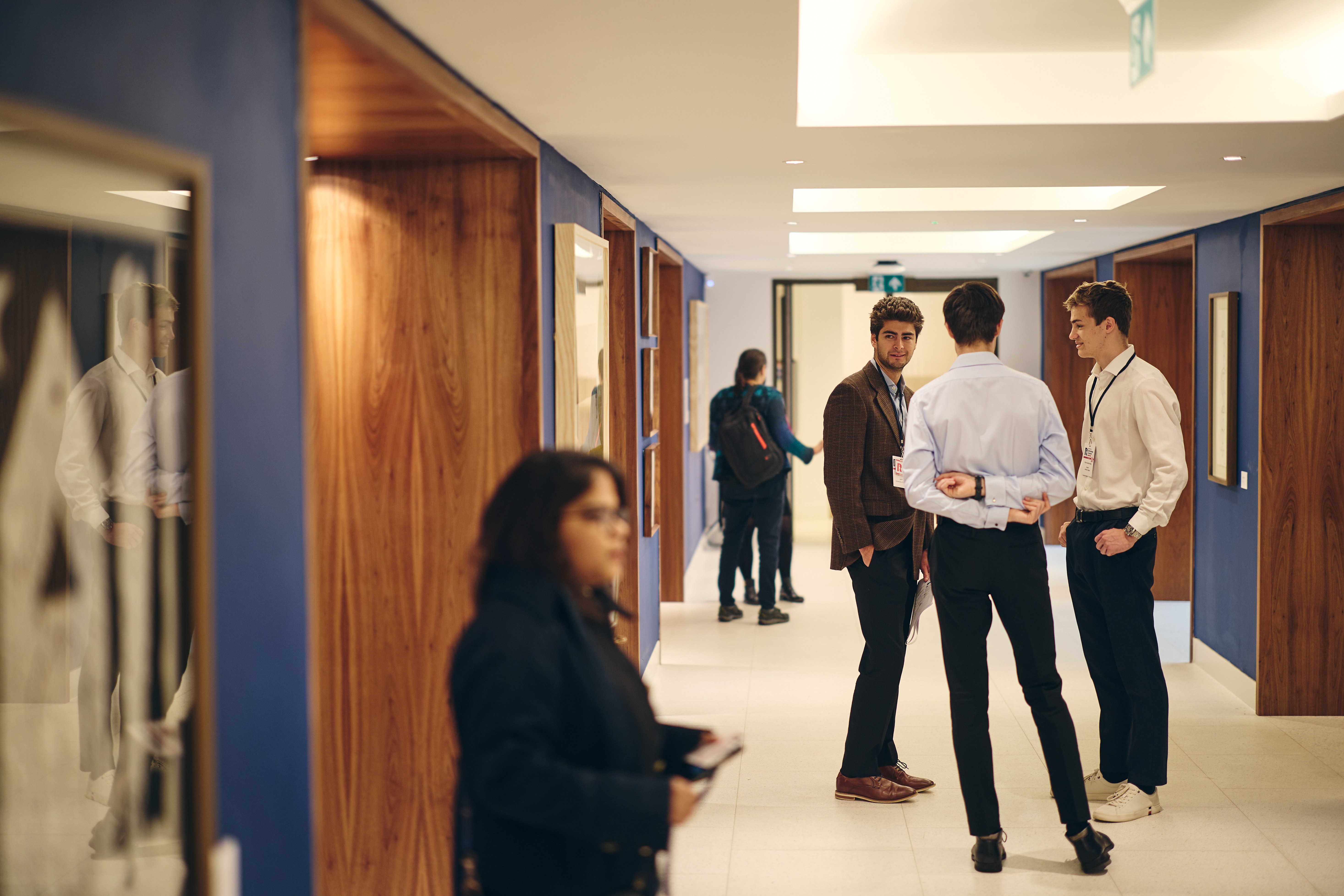 A small group talking in the art gallery during a convening