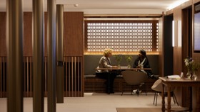 Conference Foyer nooks with tables and chairs. Two guests are seated in the nook.