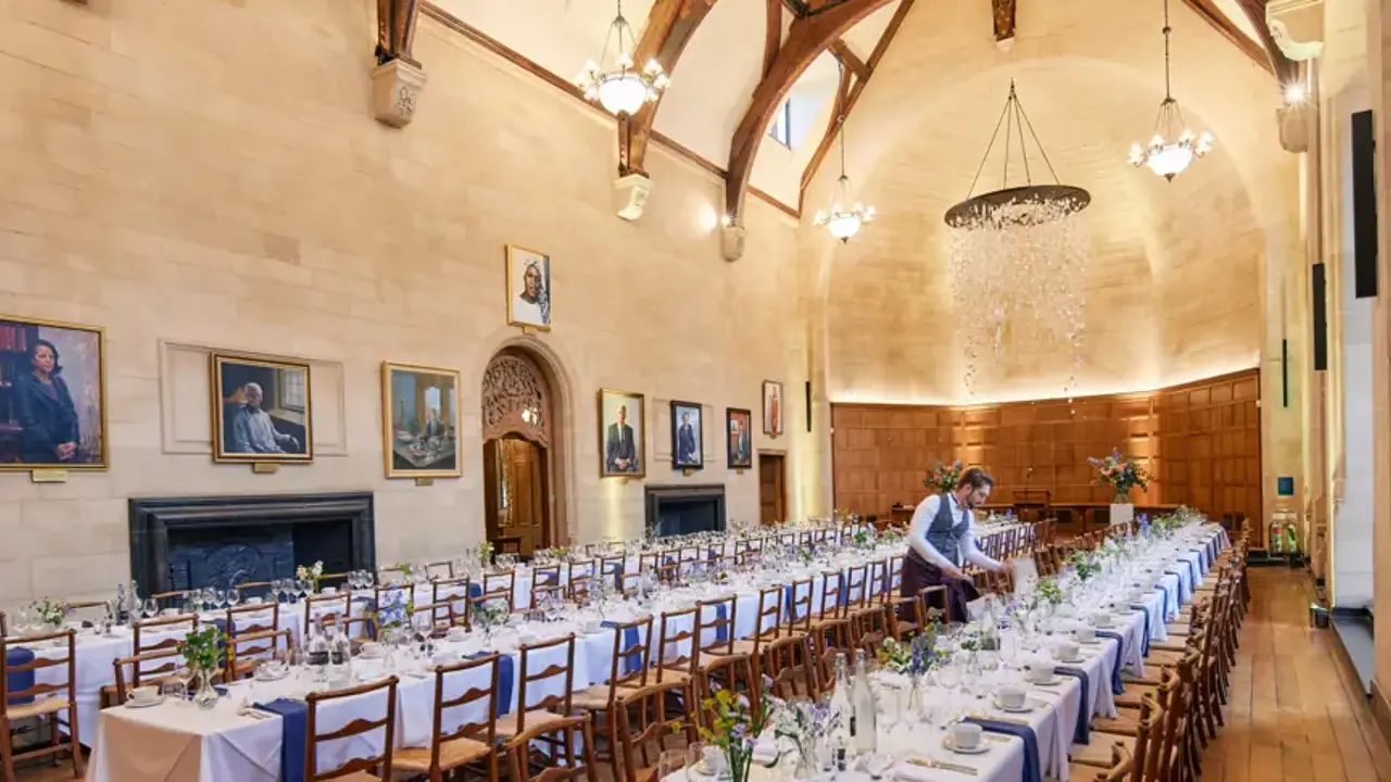 Image of hall with tables set and laid out for dinner