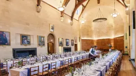 Image of hall with tables set and laid out for dinner