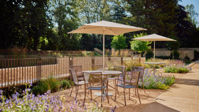 Table And Chairs In A Sunny Rhodes House Terrace