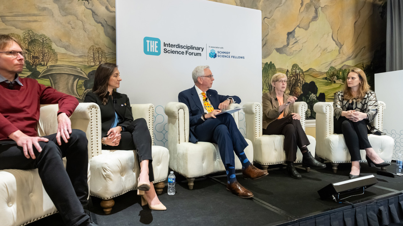 Five panellists in discussion on recognising and rewarding interdisciplinary achievement.