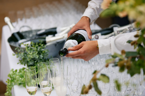 Pouring Sparkling Wine Into Glasses At Rhodes House