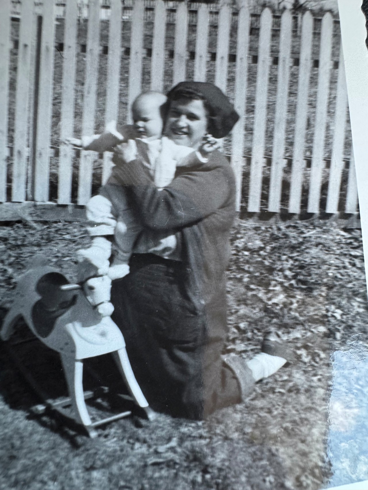 Black and white photo of grandmother holding baby.