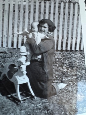 Black and white photo of grandmother holding baby.