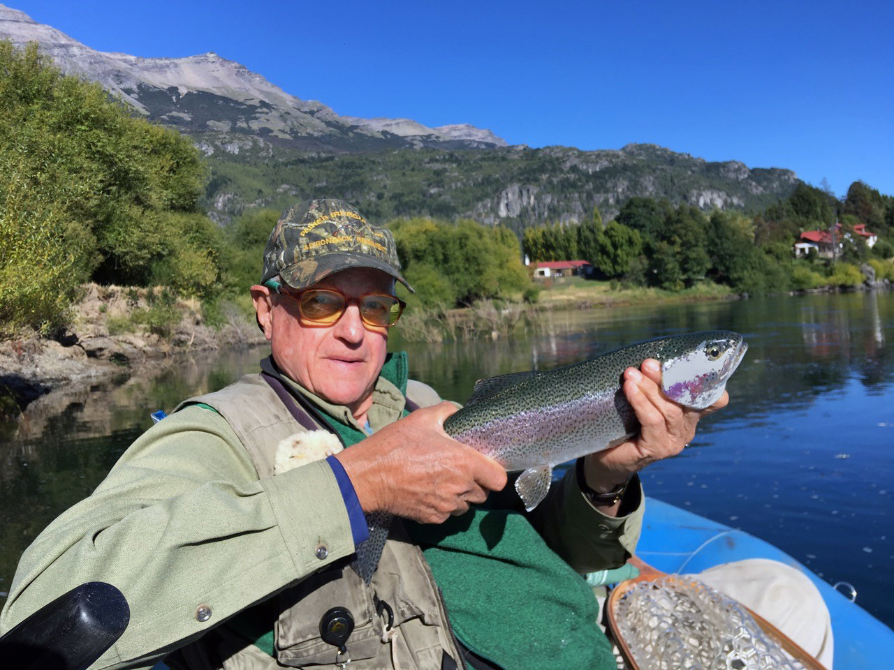 Peter in a boat holding a fish in his hands.