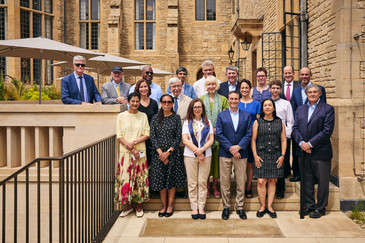 Group photo of Rhodes Trustees and guests standing next to translation stones for the new and old inscriptions