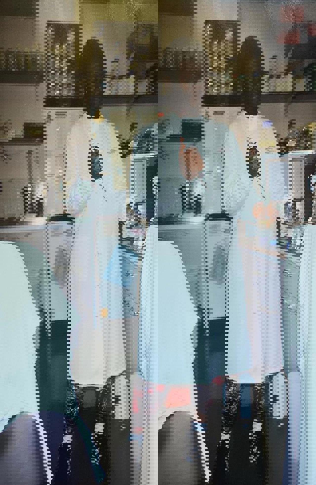 Rachel stood in a white lab coat holding a syringe