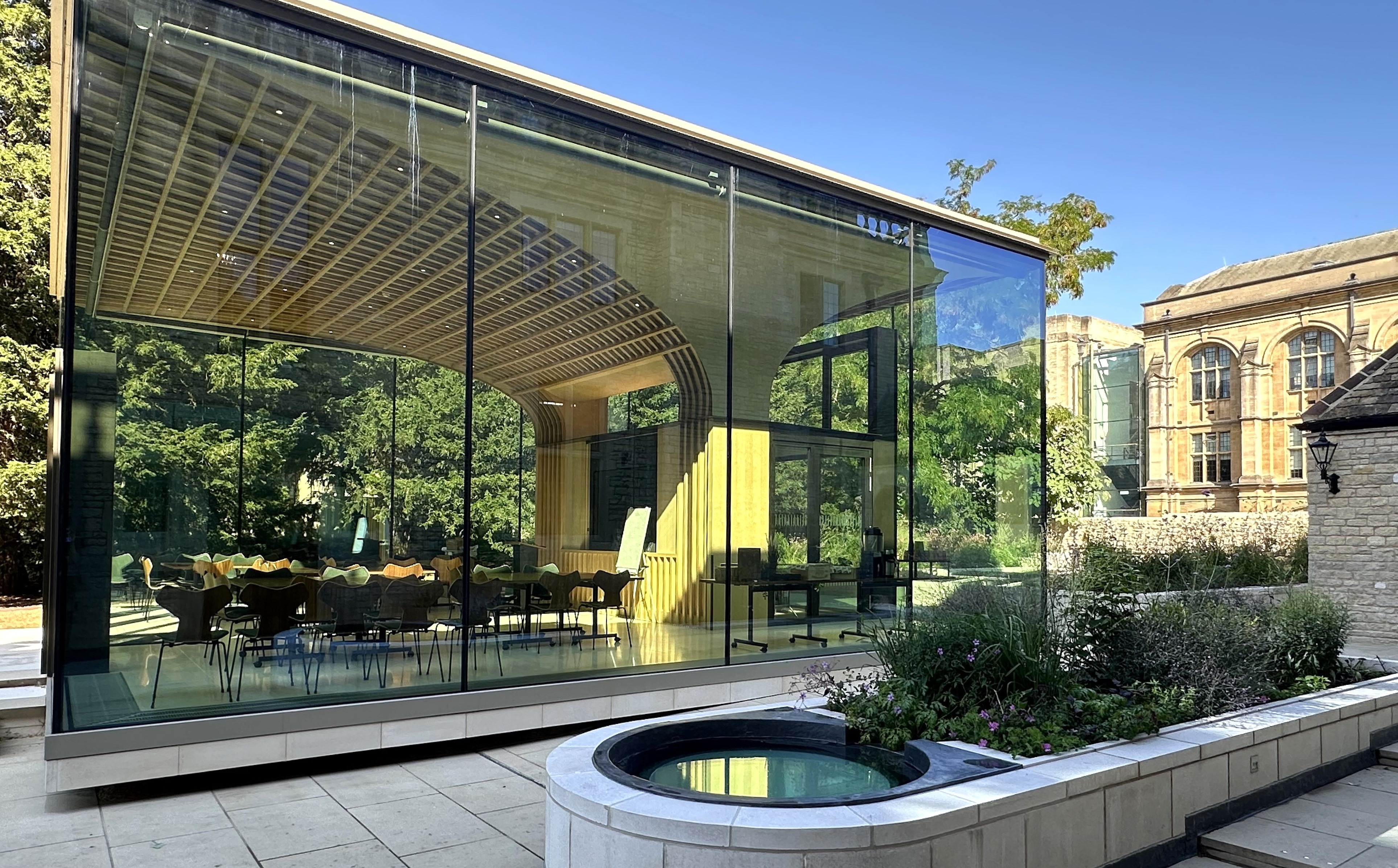 A daytime view of the Rhodes House Glass Pavilion from the west door of Rhodes House. 