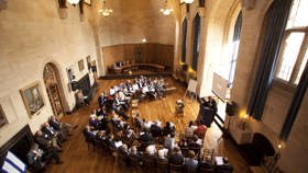 Rhodes House conference in McCall MacBain Hall with delegates in semicircle seating facing bay window