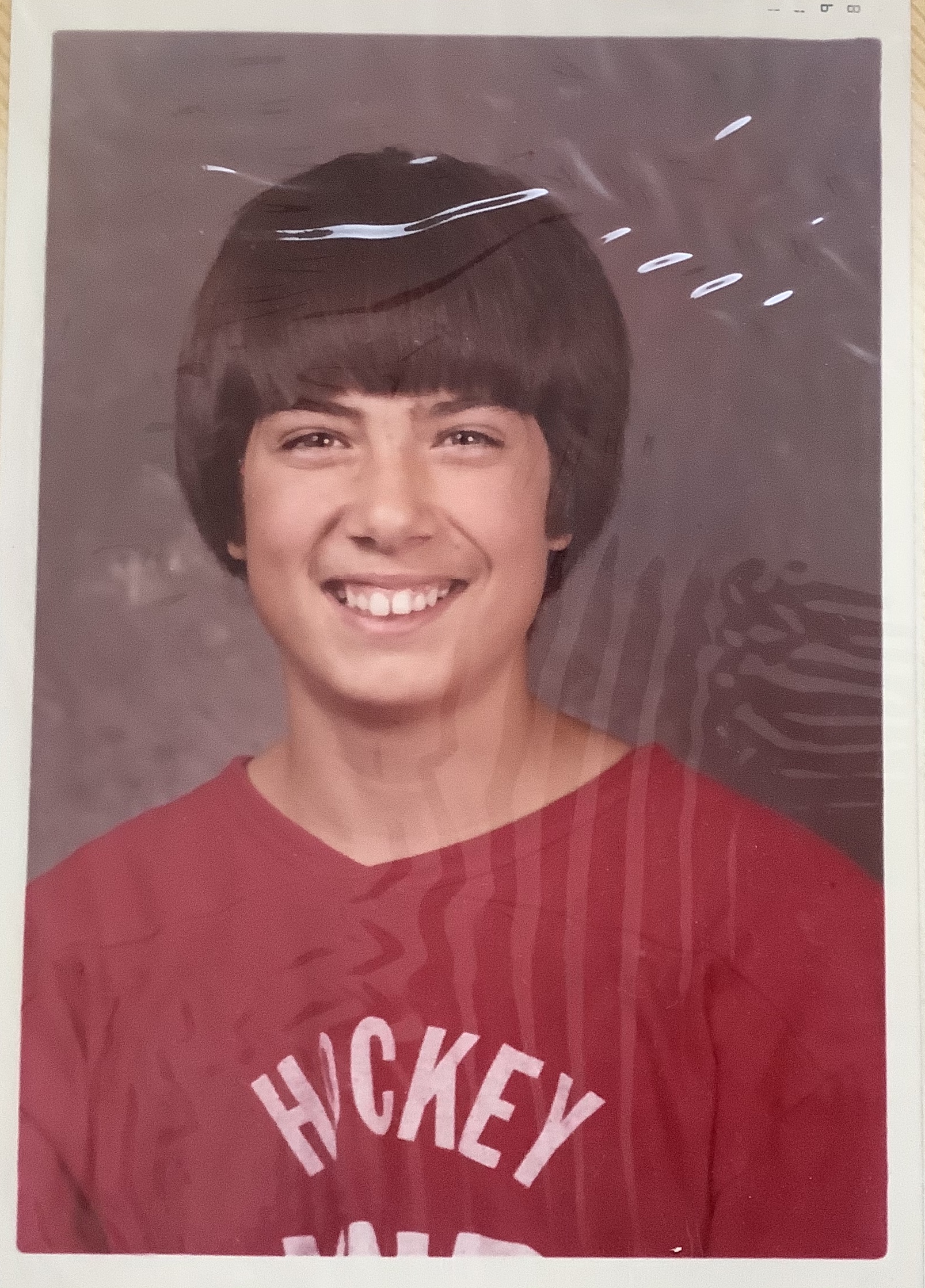 Formal photo of young Paul, he is wearing a red top that reads 'Hockey'
