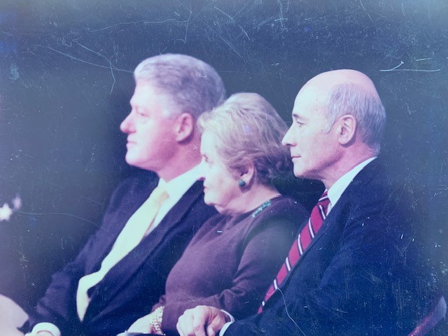 A picture showing side profiles of Bill Clinton, Madeleine Albright and Joseph. They are all dressed formally.
