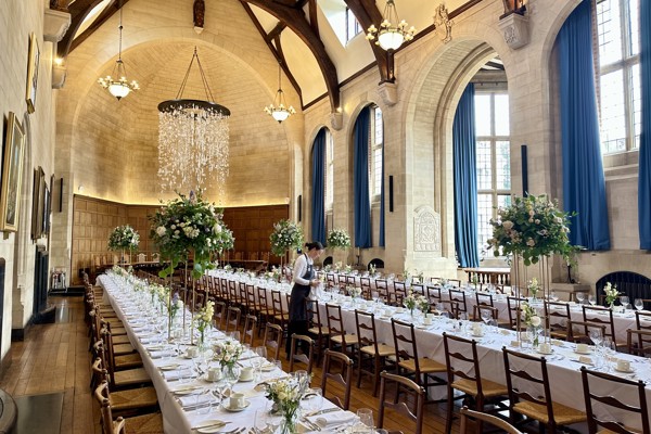 McCall MacBain Hall with banquet tables laid for a wedding meal and the top table in the background.