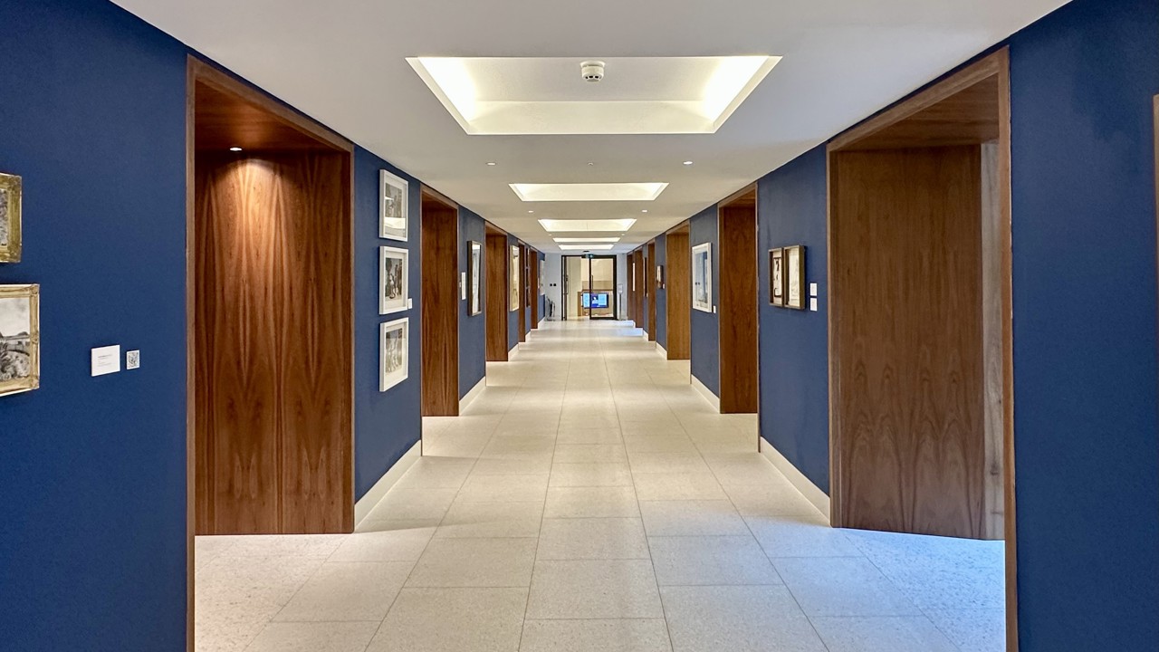 Lobby of the Conference Foyer with artwork hanging on the blue walls.