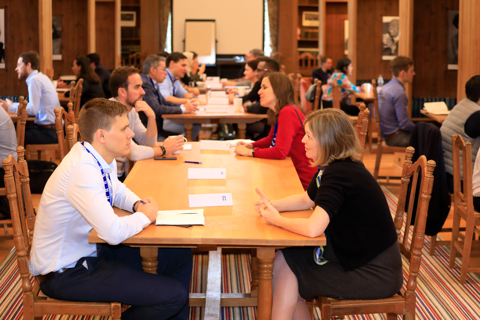 Speed mentoring with two people talking across a table