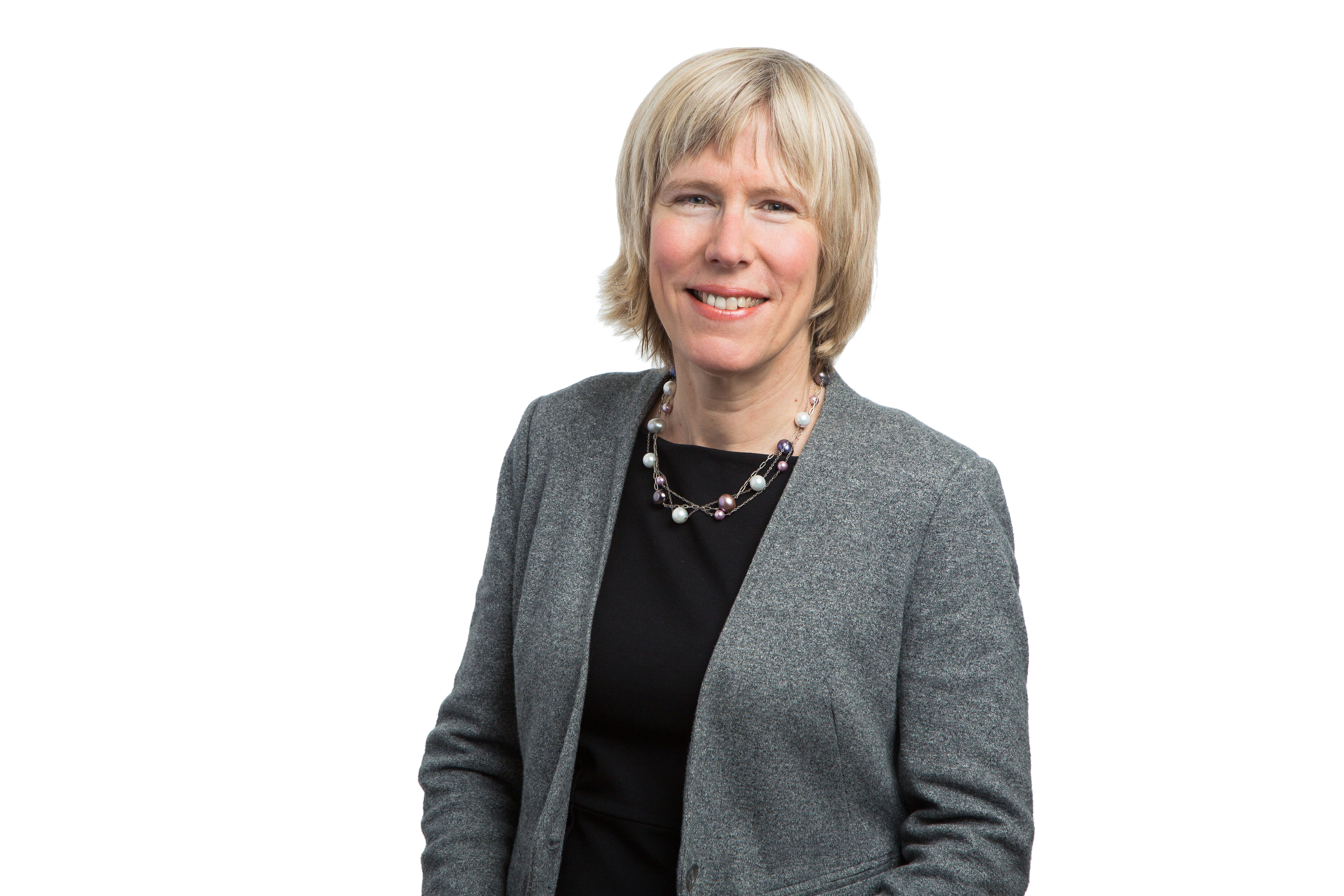Headshot photo of Meredith wearing a black top, gray blazer, and smiling into the camera.