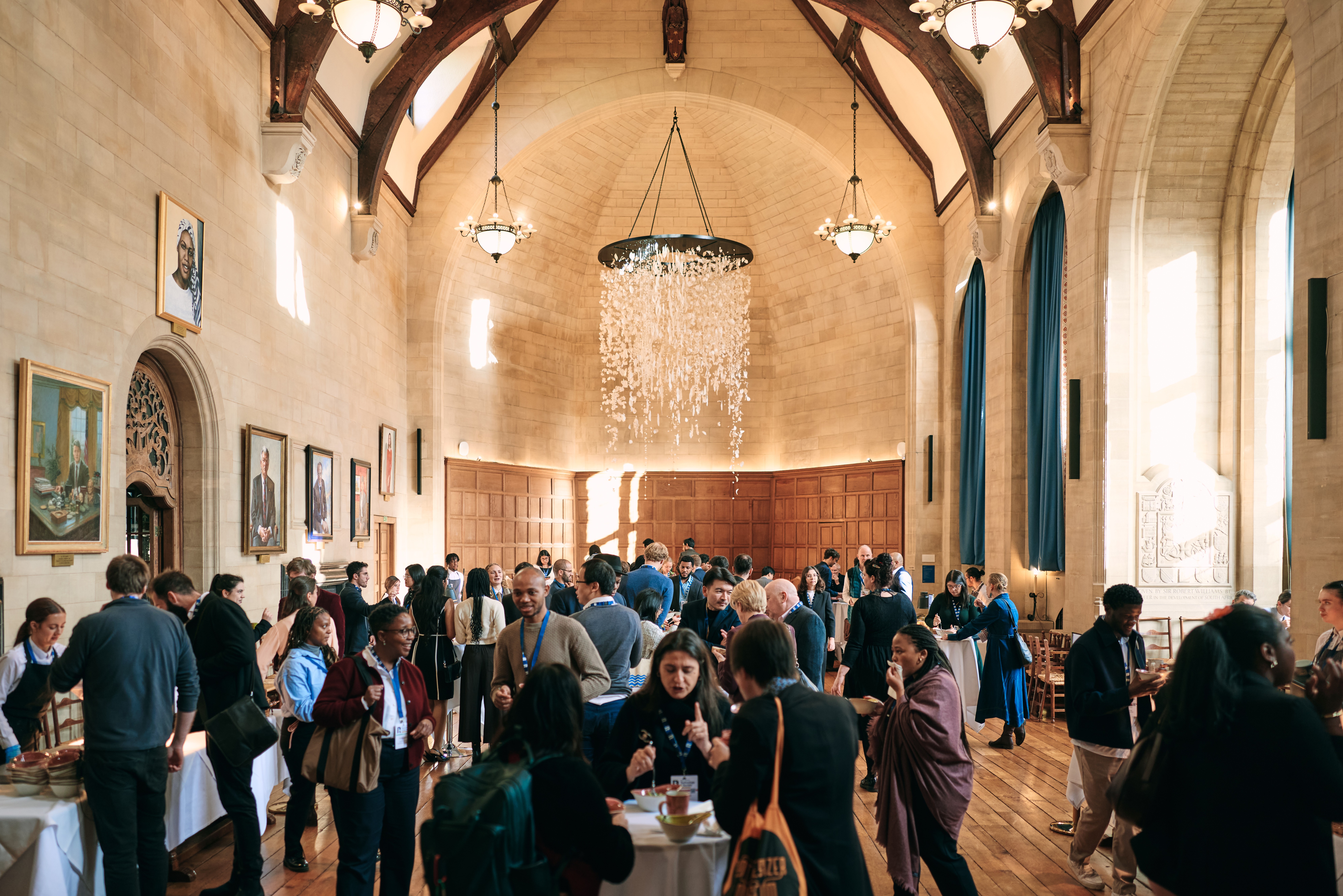 Delegates mingling and eating during a reception in McCall MacBain Hall