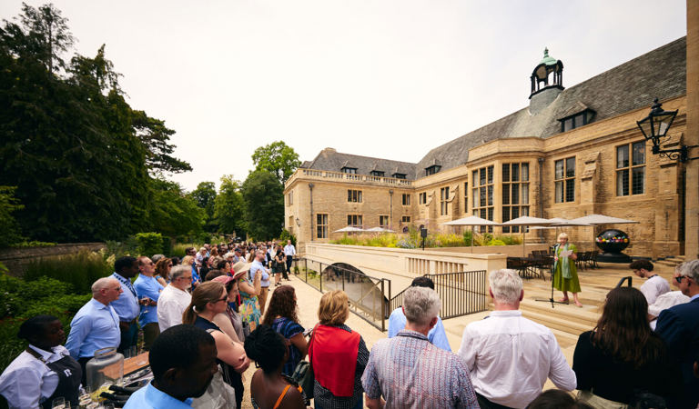 Professor Elleke Boehmer addresses a crowd in the Rhodes House gardens